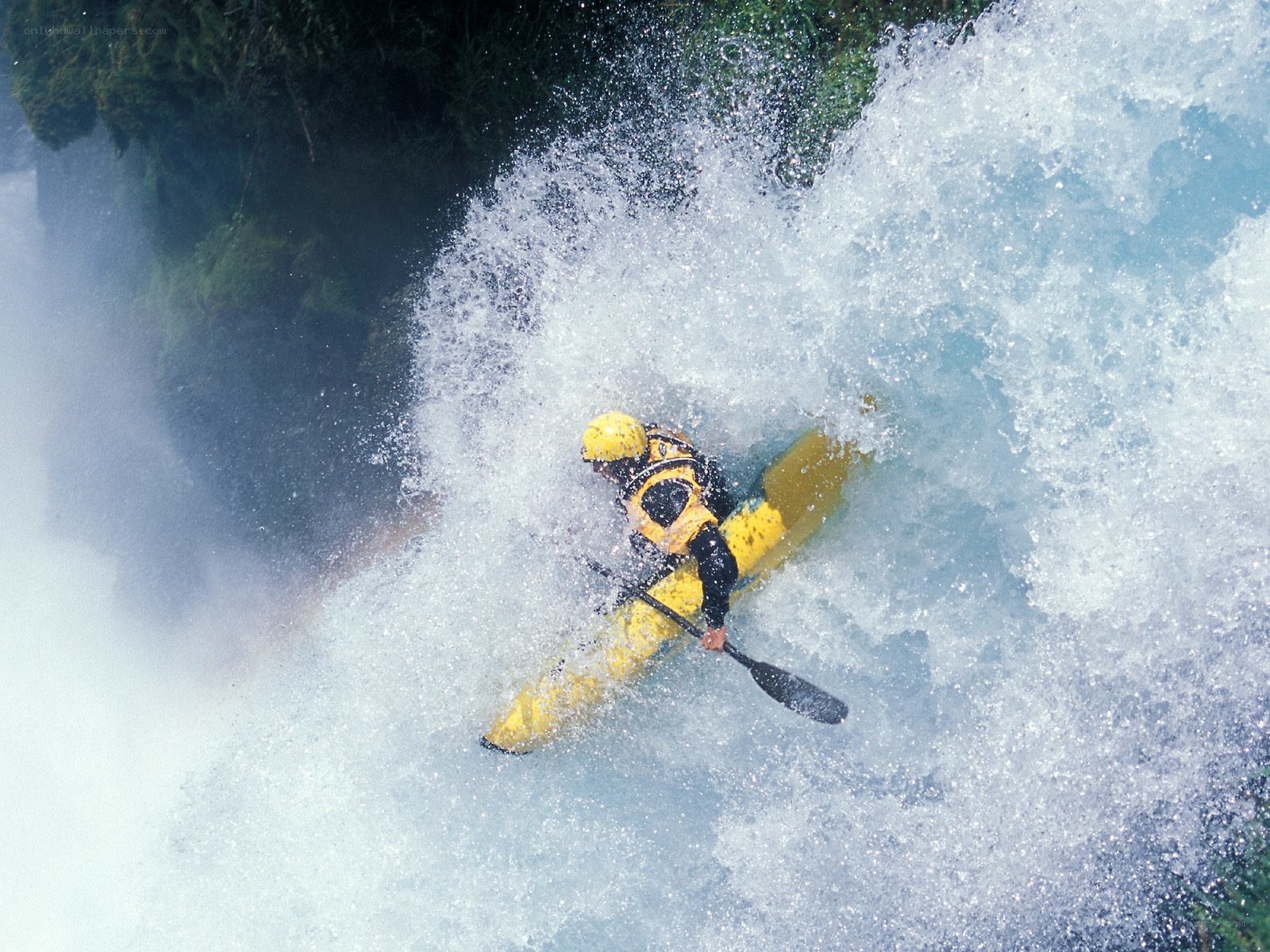 kayaker navigating whitewater rapids
