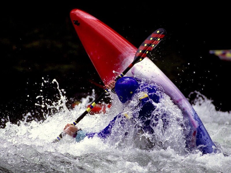 kayaker navigating whitewater rapids