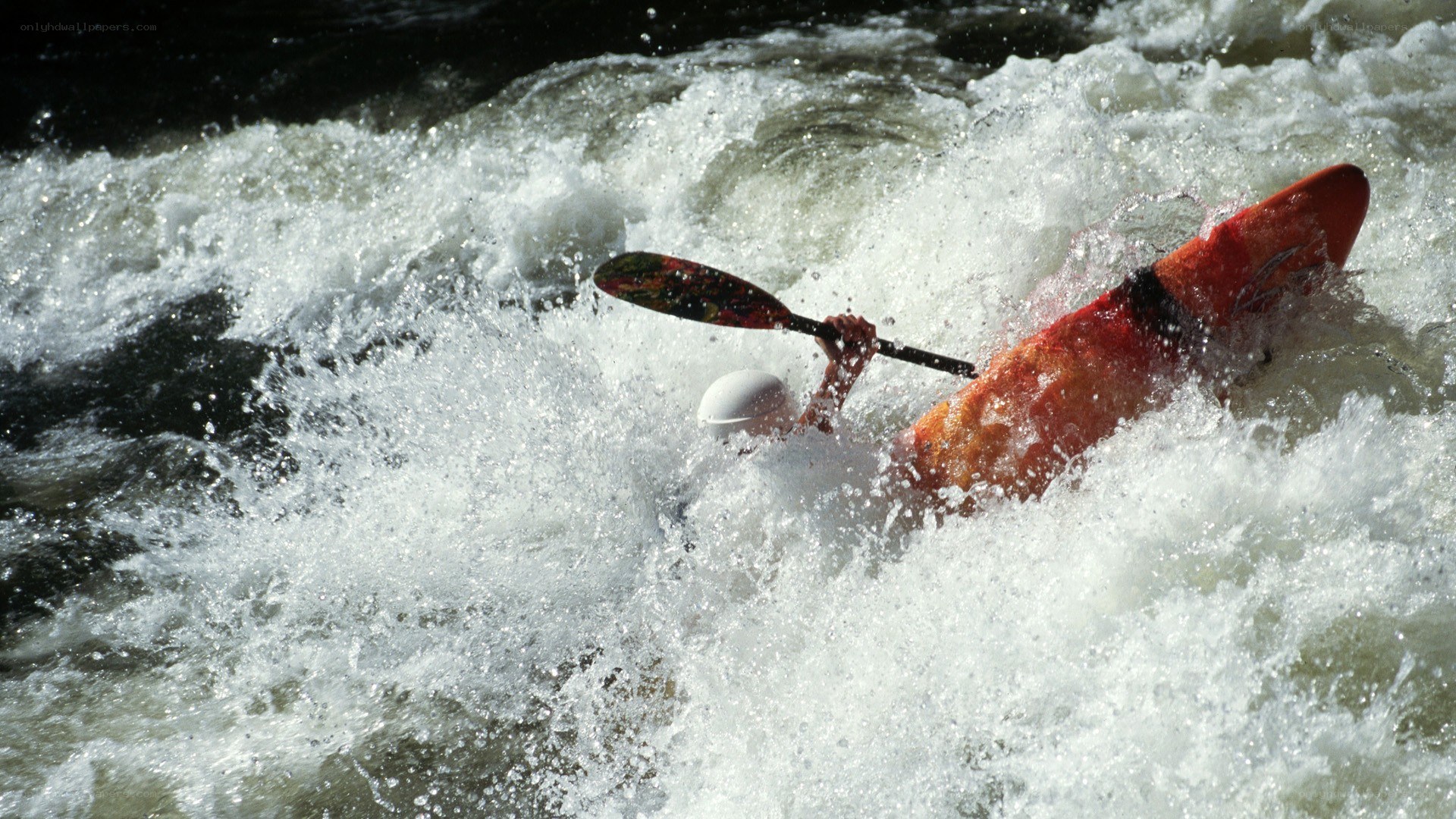 kayaker navigating whitewater rapids