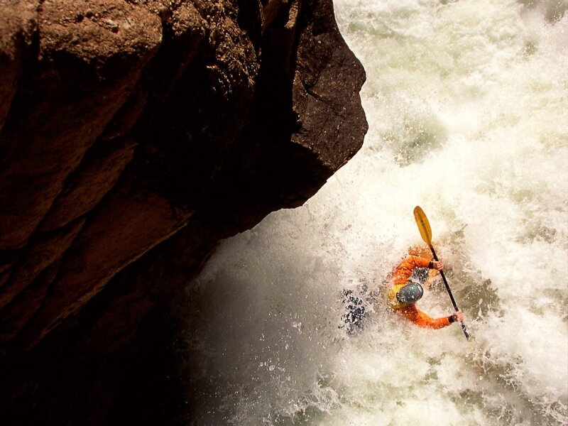 Kayaker navigating whitewater rapids