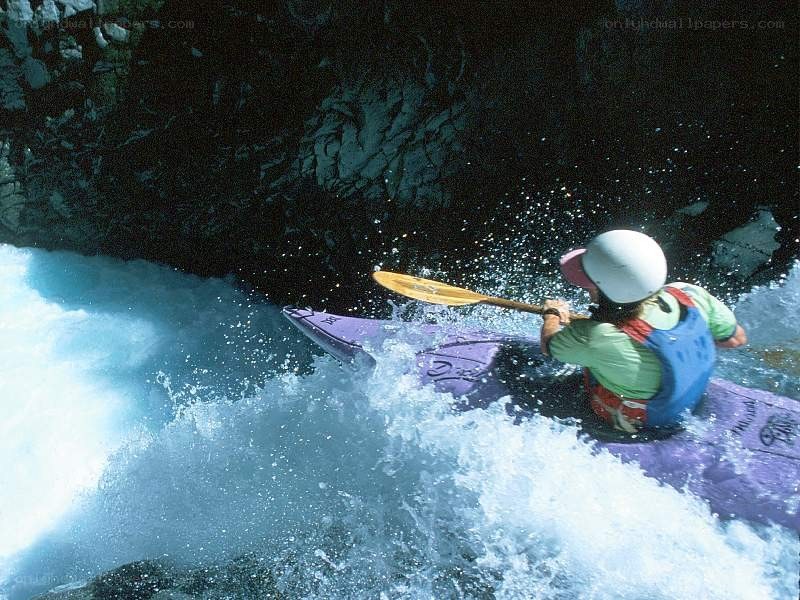 kayaker navigating whitewater rapids