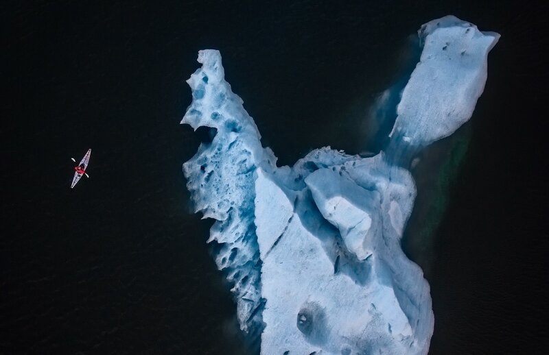 Kayaker Near Iceberg