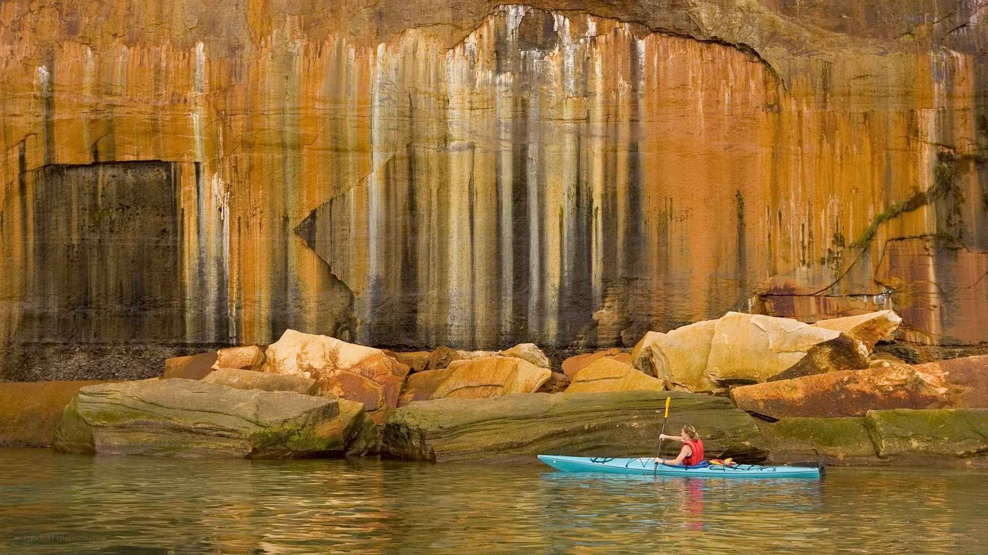 kayaker near rock formations
