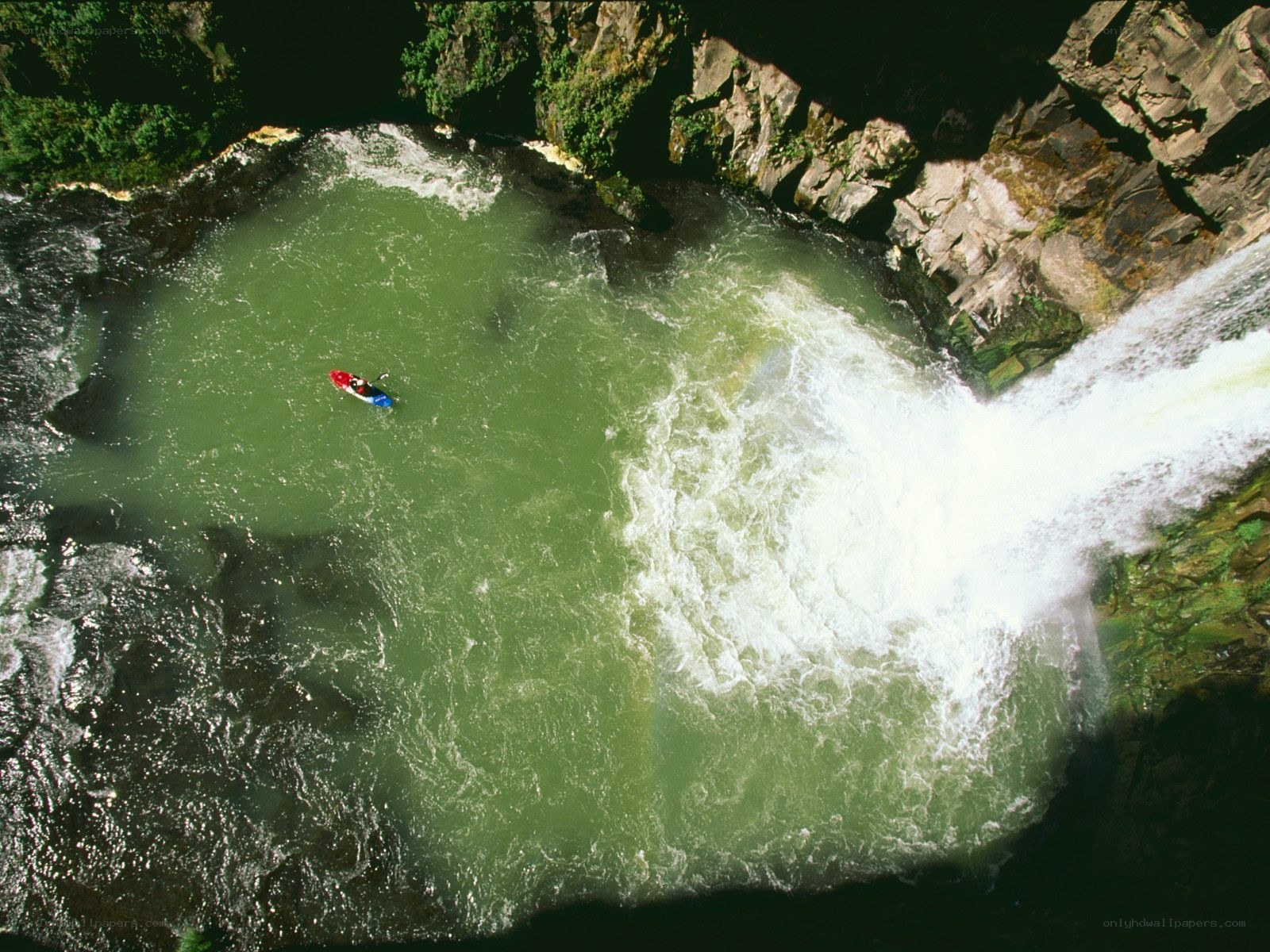 kayaker near waterfall pool