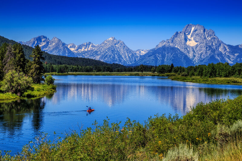Kayaker on a Lake — Blue, Serene, Afternoon
