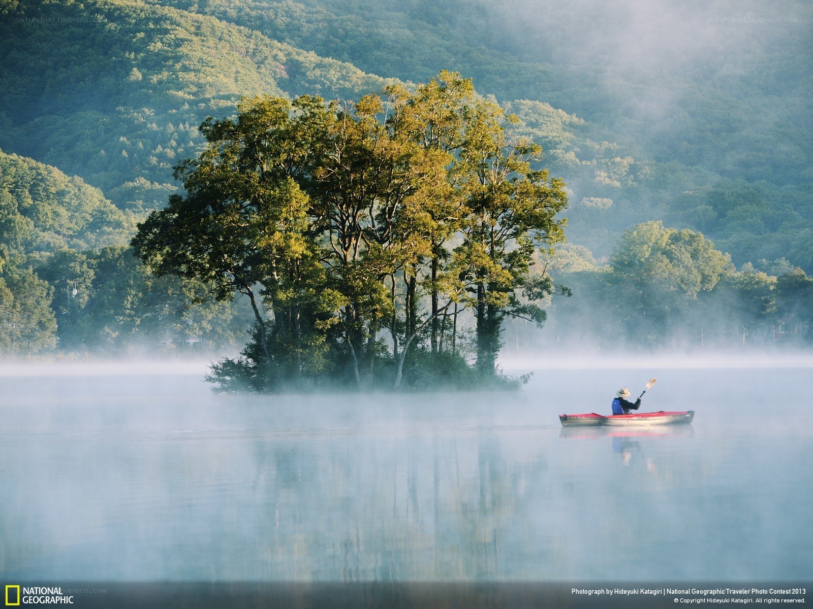 Kayaker on a misty lake