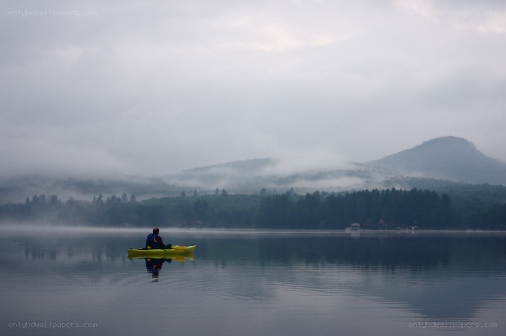 kayaker on a misty lake