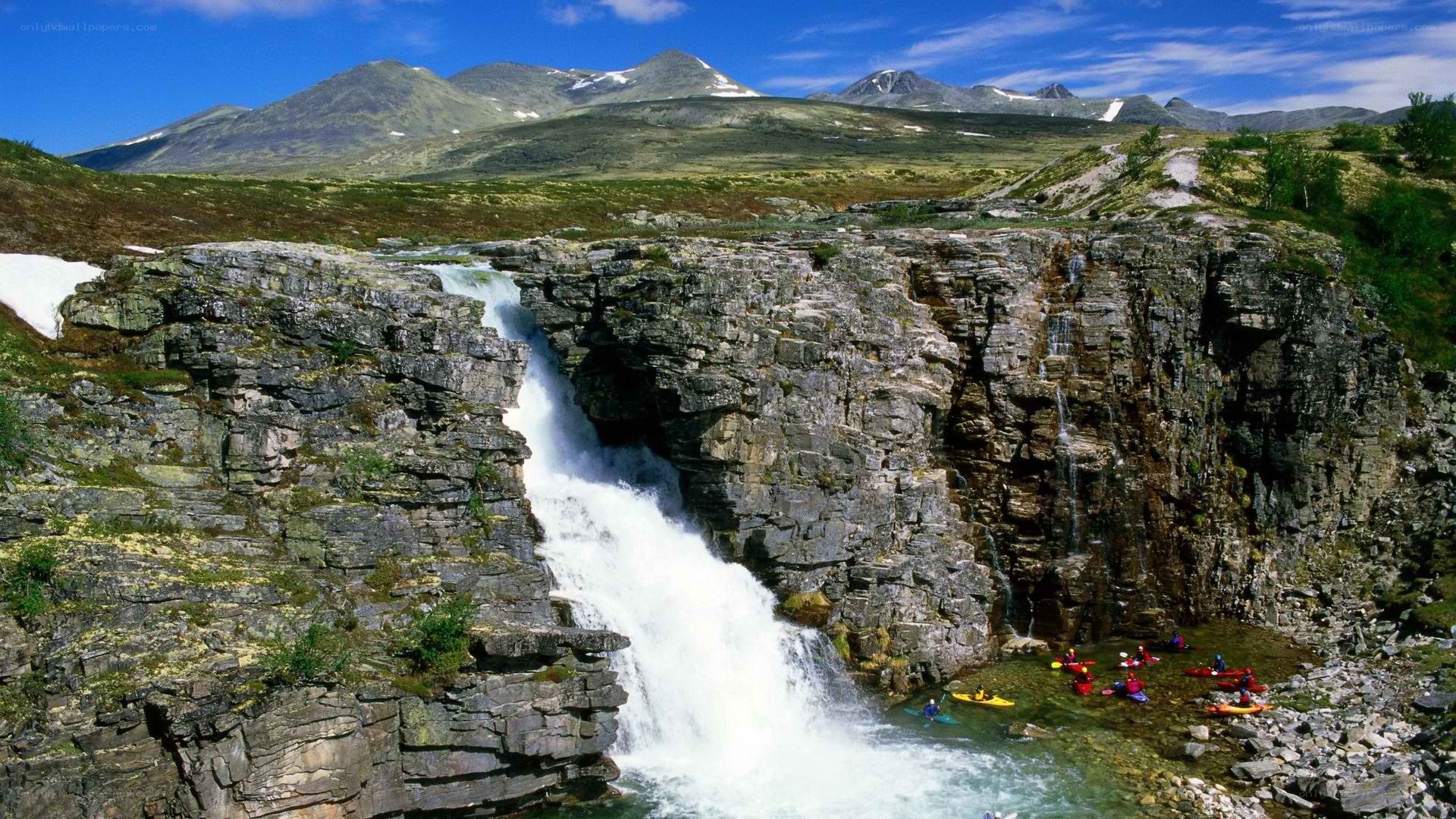 Kayakers at a mountain waterfall