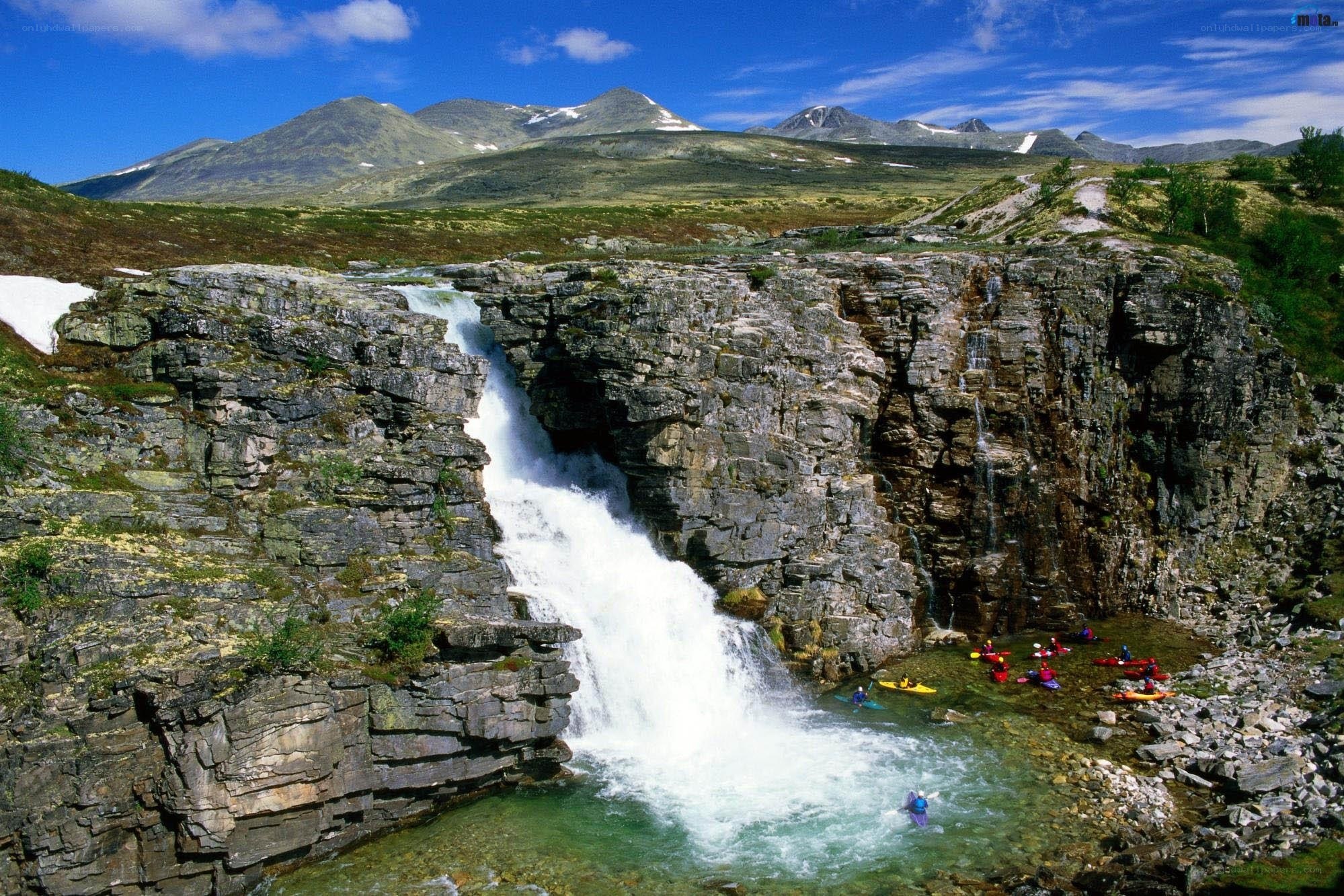 Kayakers at a mountain waterfall