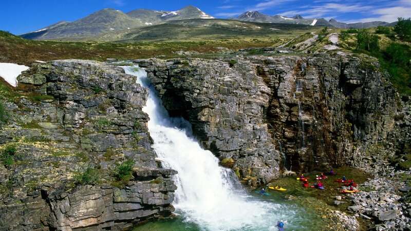 Kayakers at a waterfall in Norway