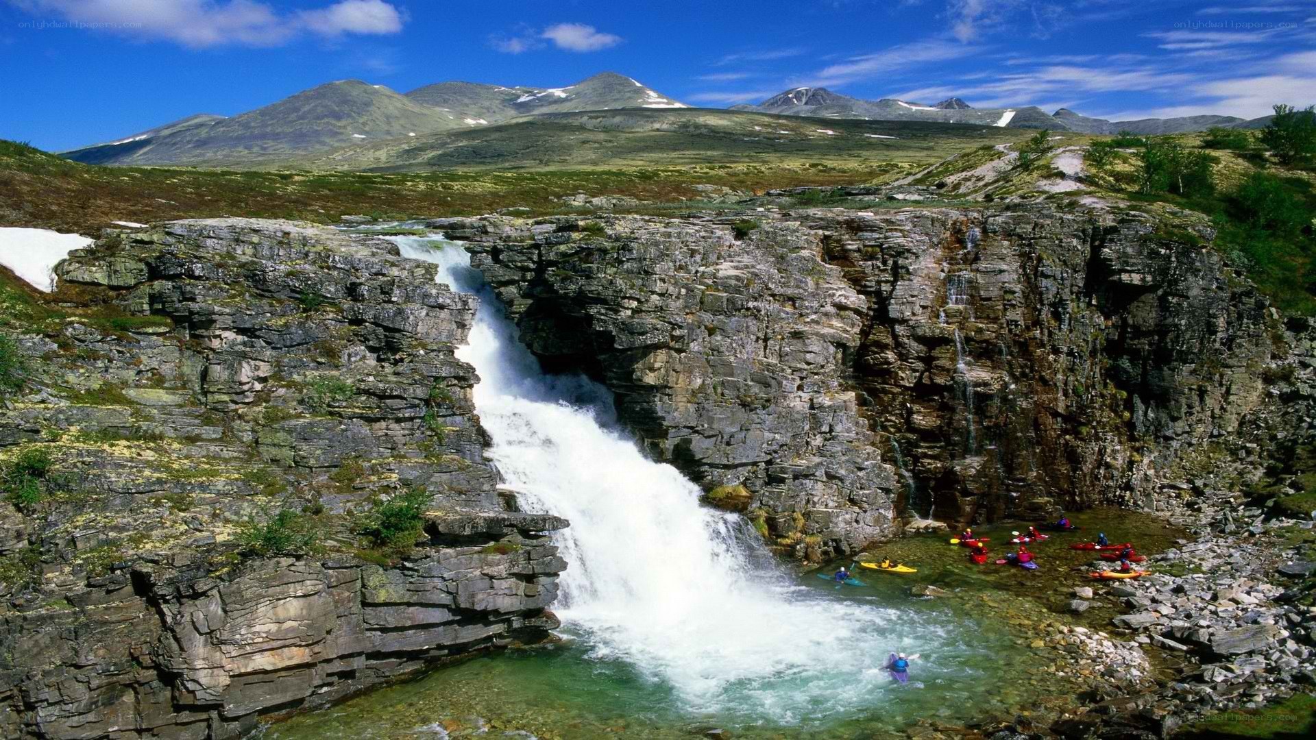 Kayakers at a waterfall