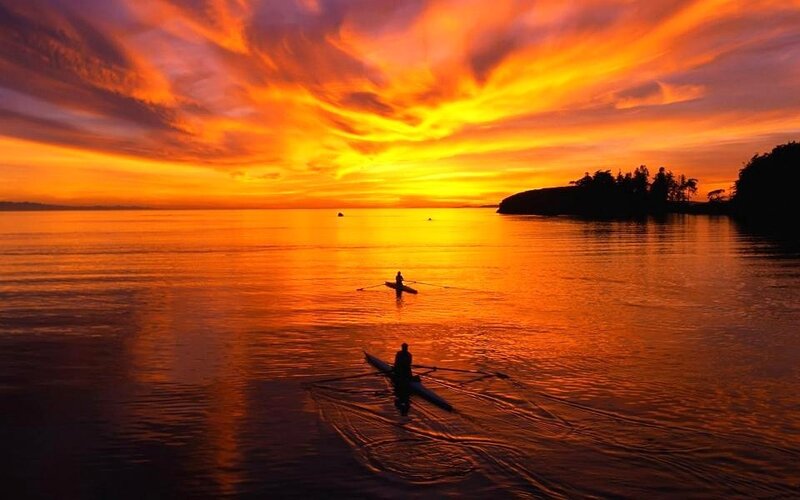 Kayakers at sunset on calm water