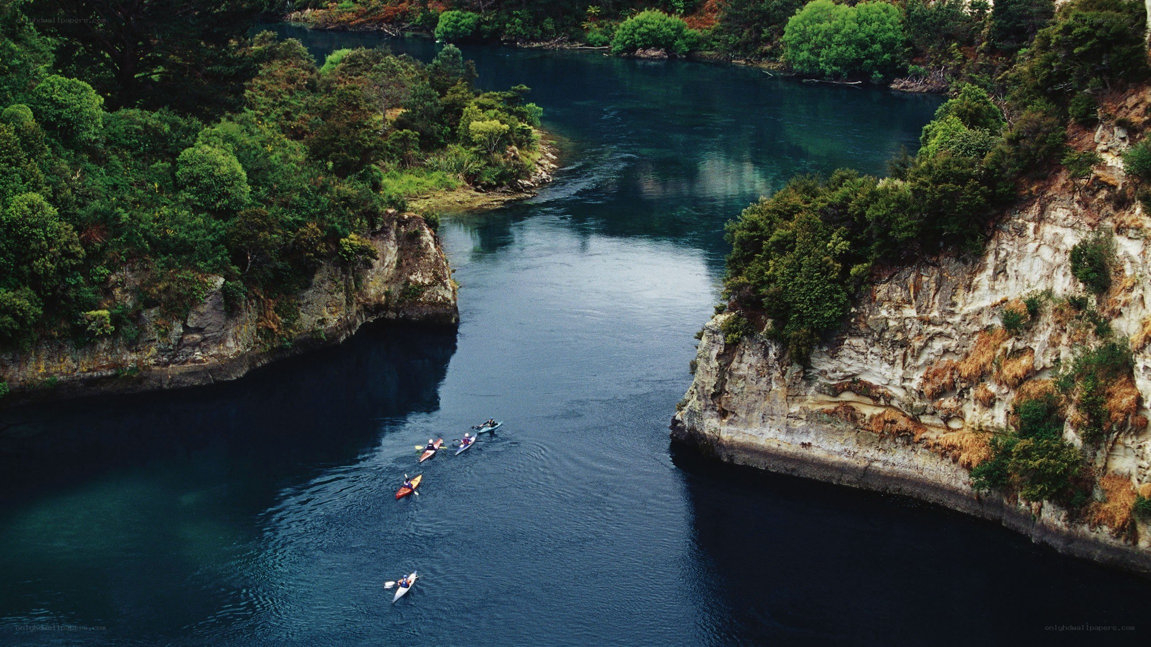 Kayakers in a river canyon