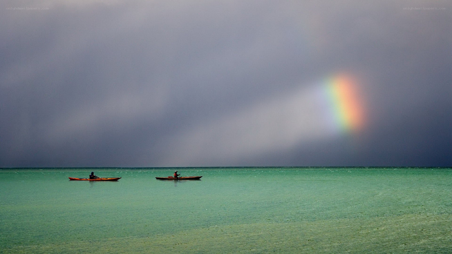 Kayakers under a rainbow