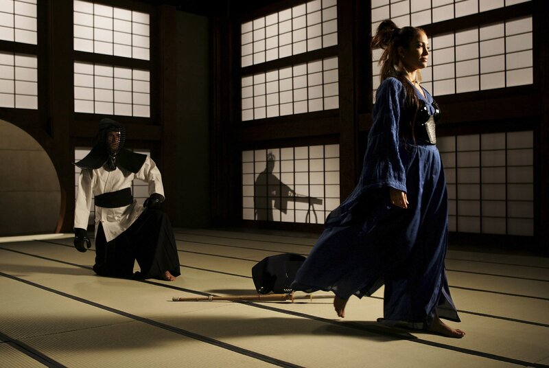 Kendo practitioner and woman in dojo