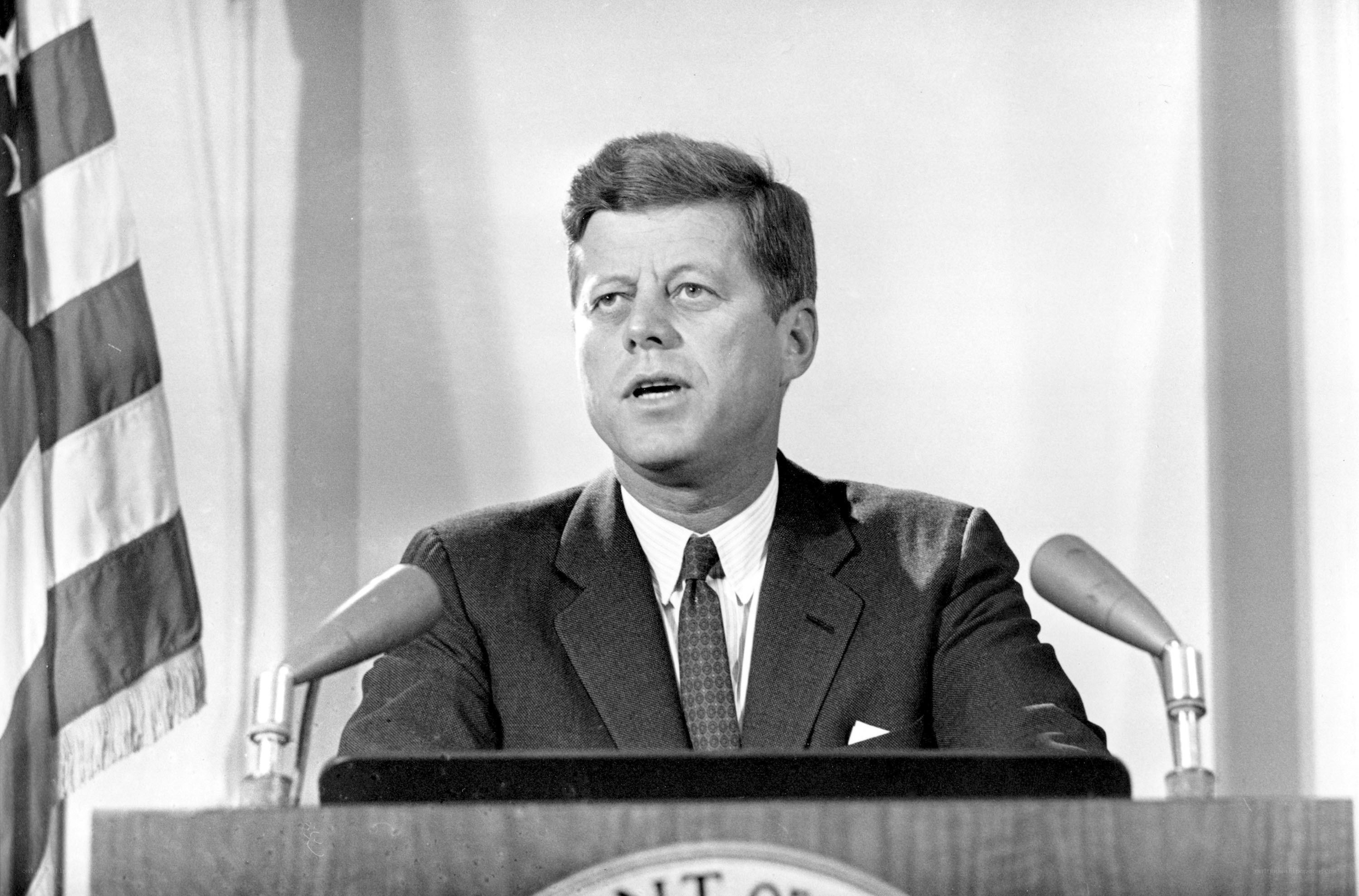 Kennedy at podium speaking