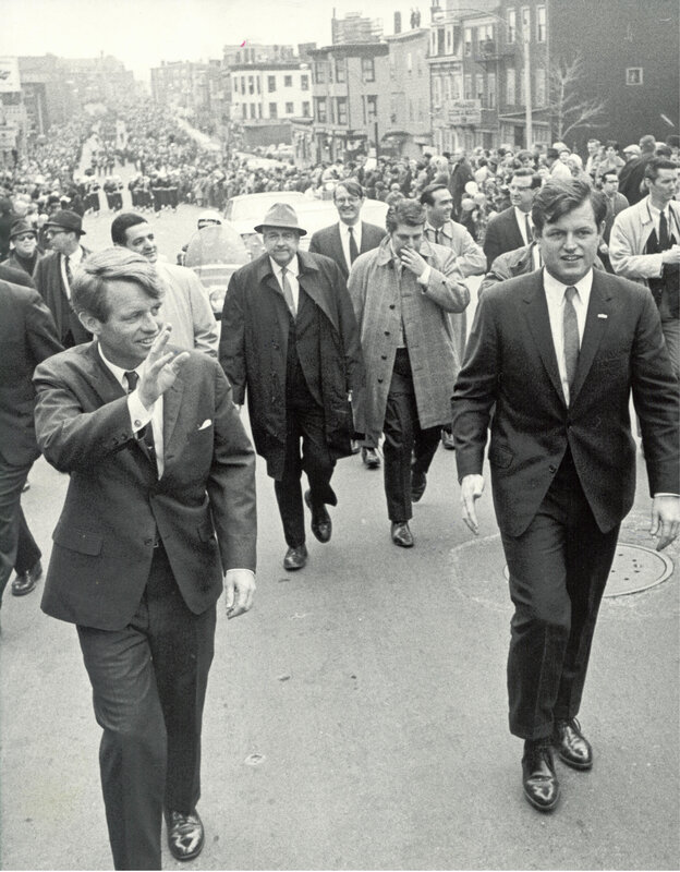 Kennedy brothers walking with crowd