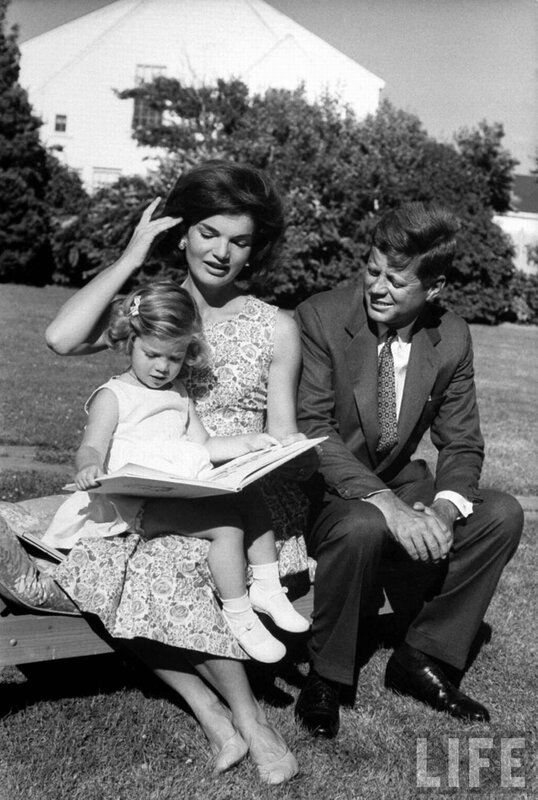 Kennedy family reading outdoors
