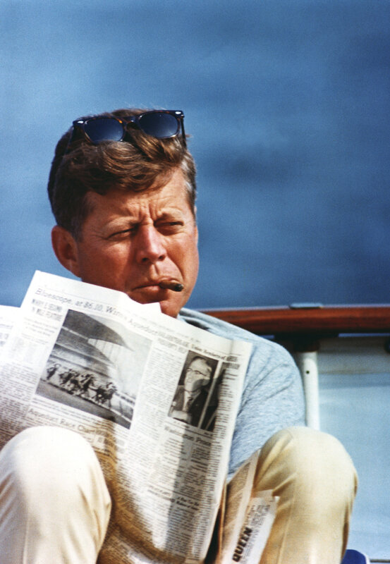 Kennedy reading newspaper