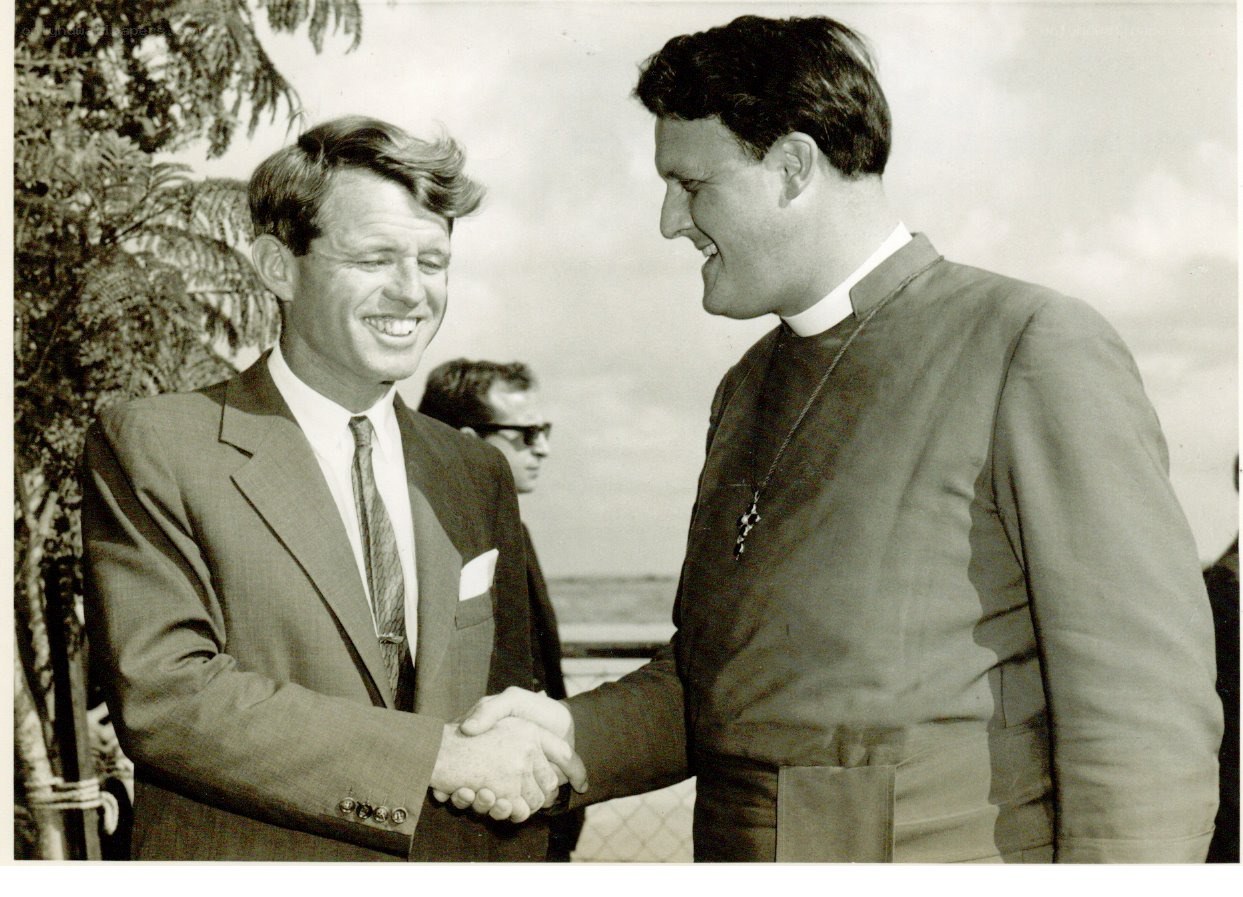 Kennedy shaking hands with priest