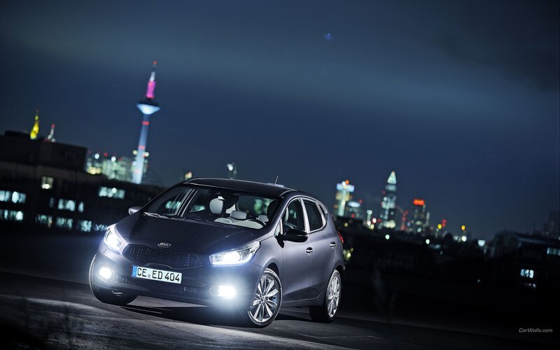 Kia car at night with city skyline