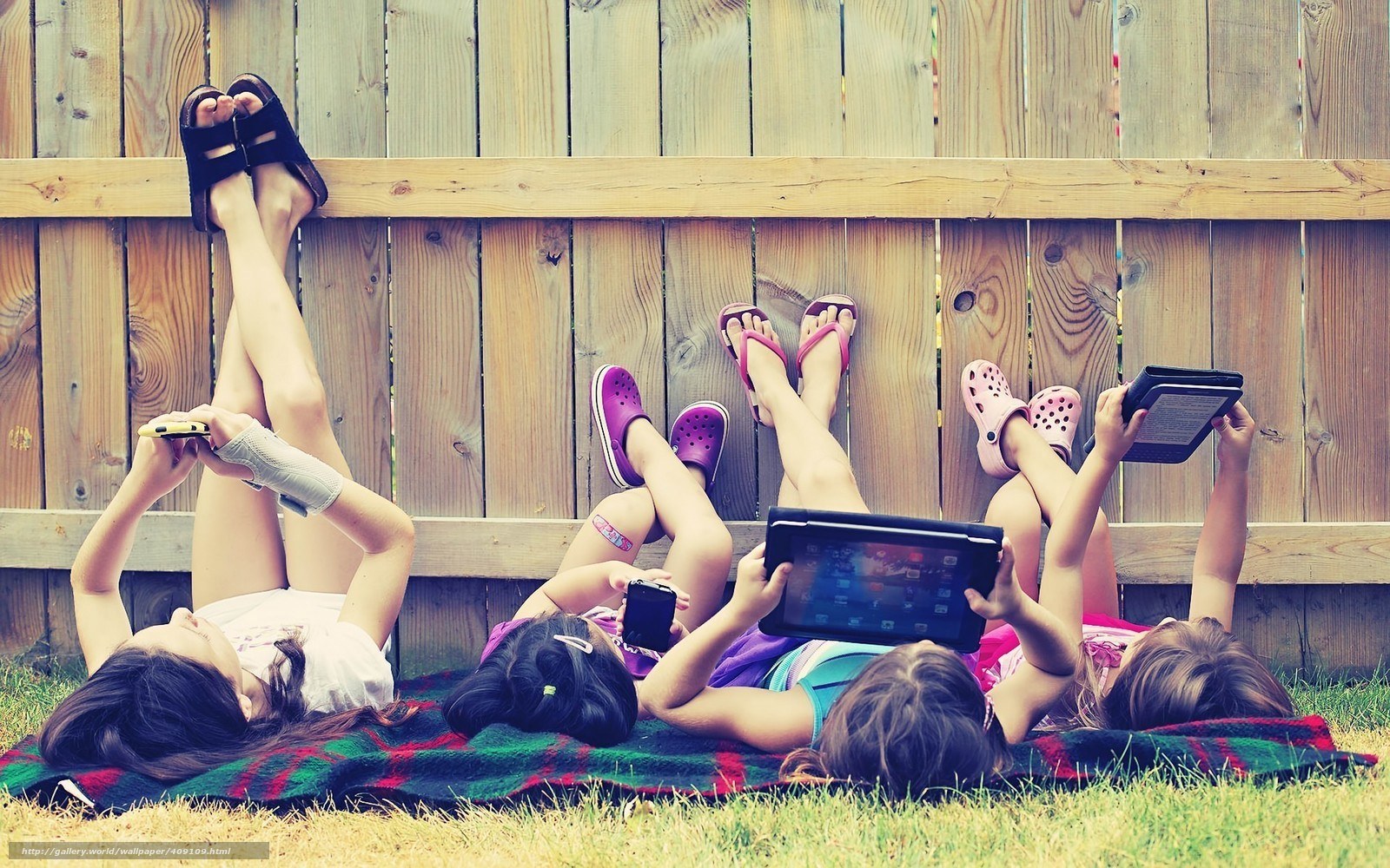 Kids using tablets outdoors