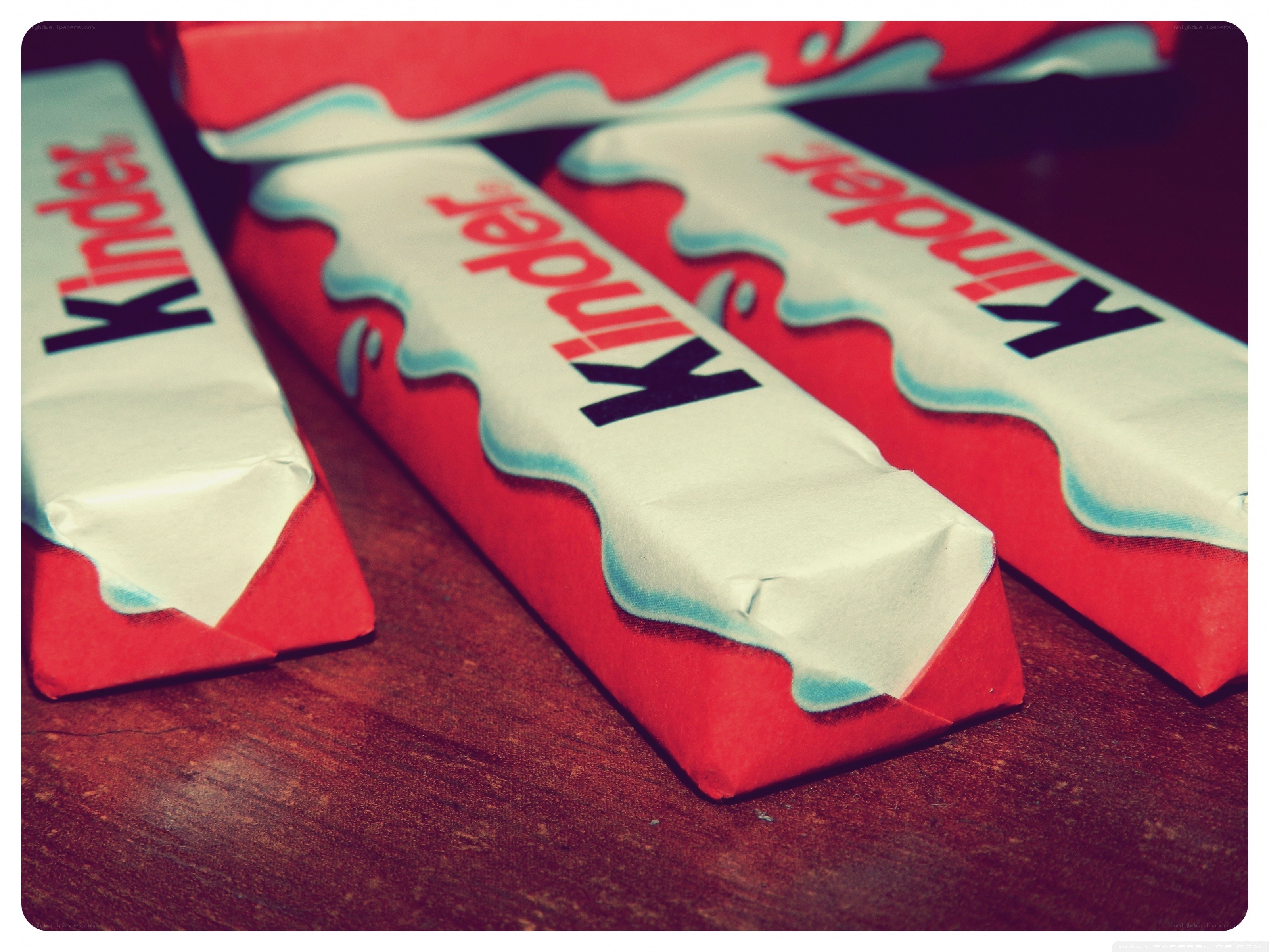 Kinder chocolate bars on wood