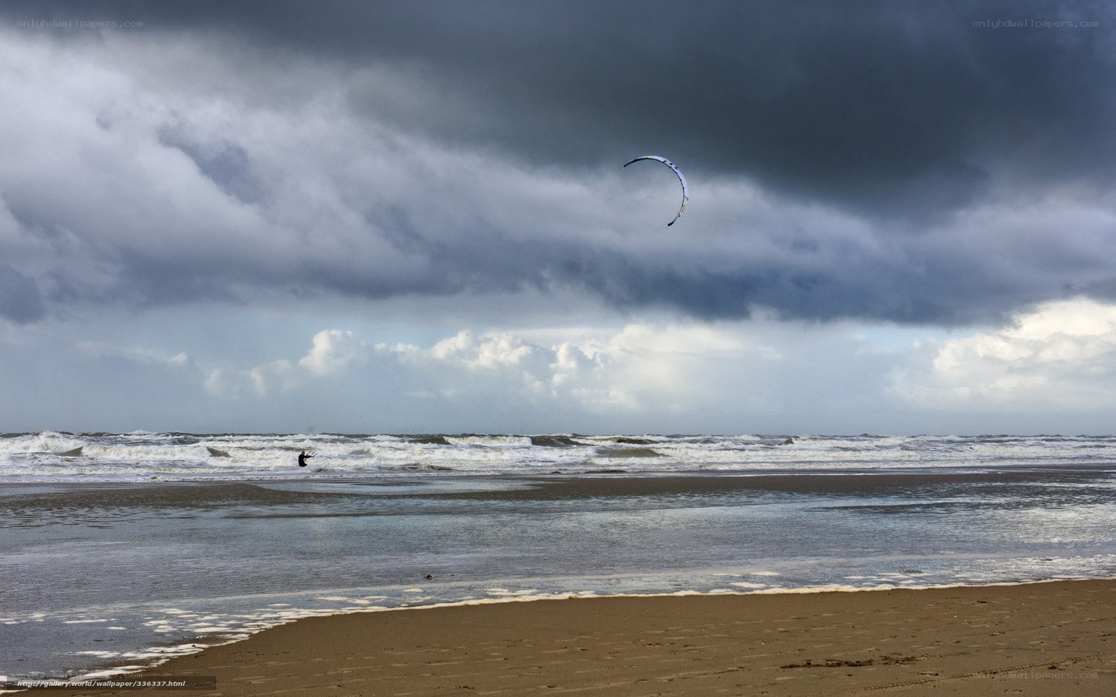 Kite surfer on a stormy beach