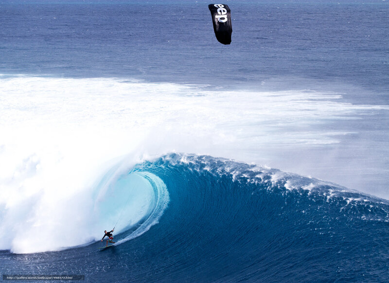 kite surfer riding wave