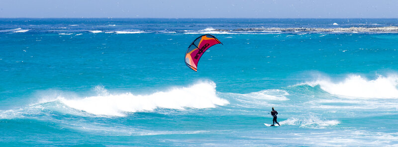 kite surfer riding waves
