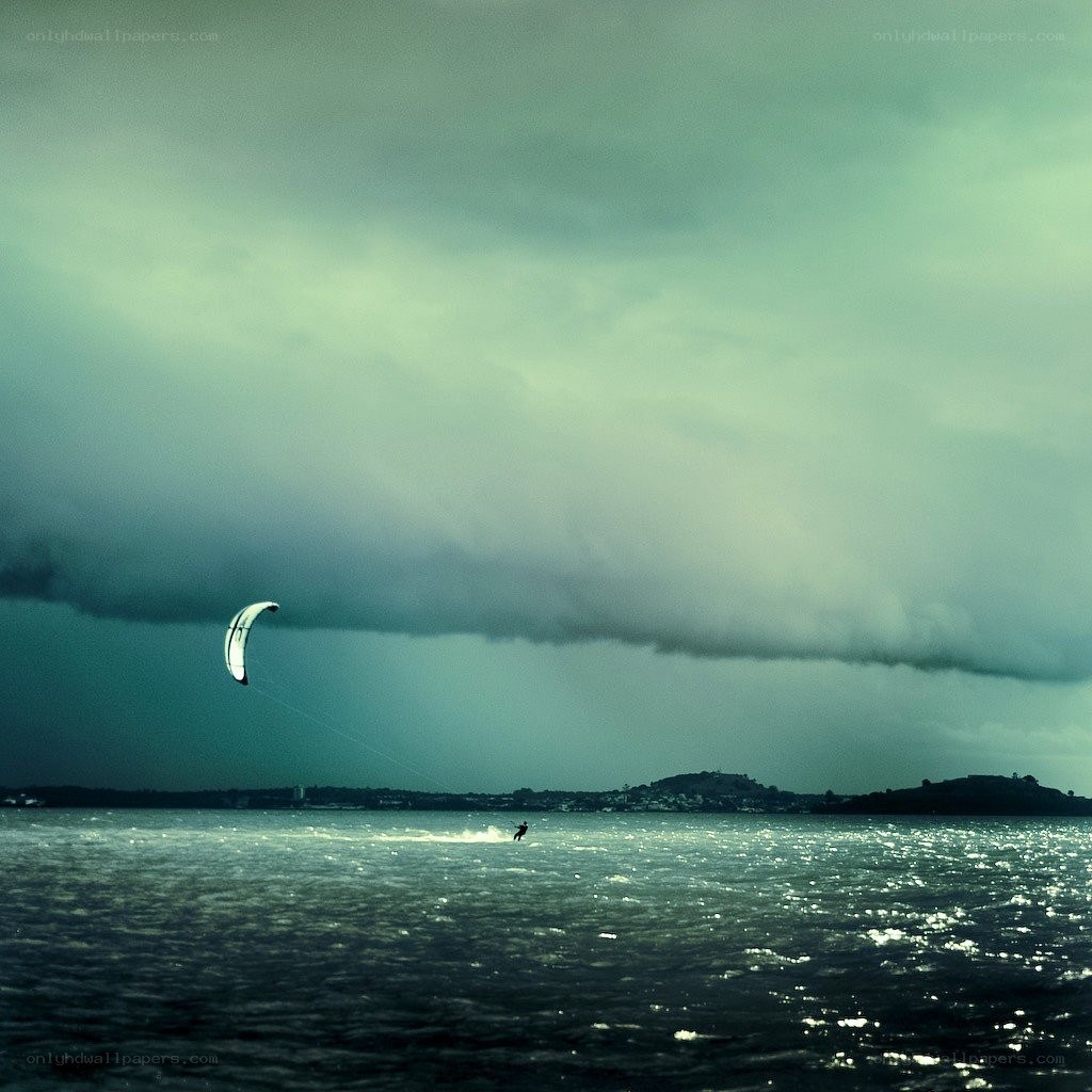 Kite surfer under stormy sky