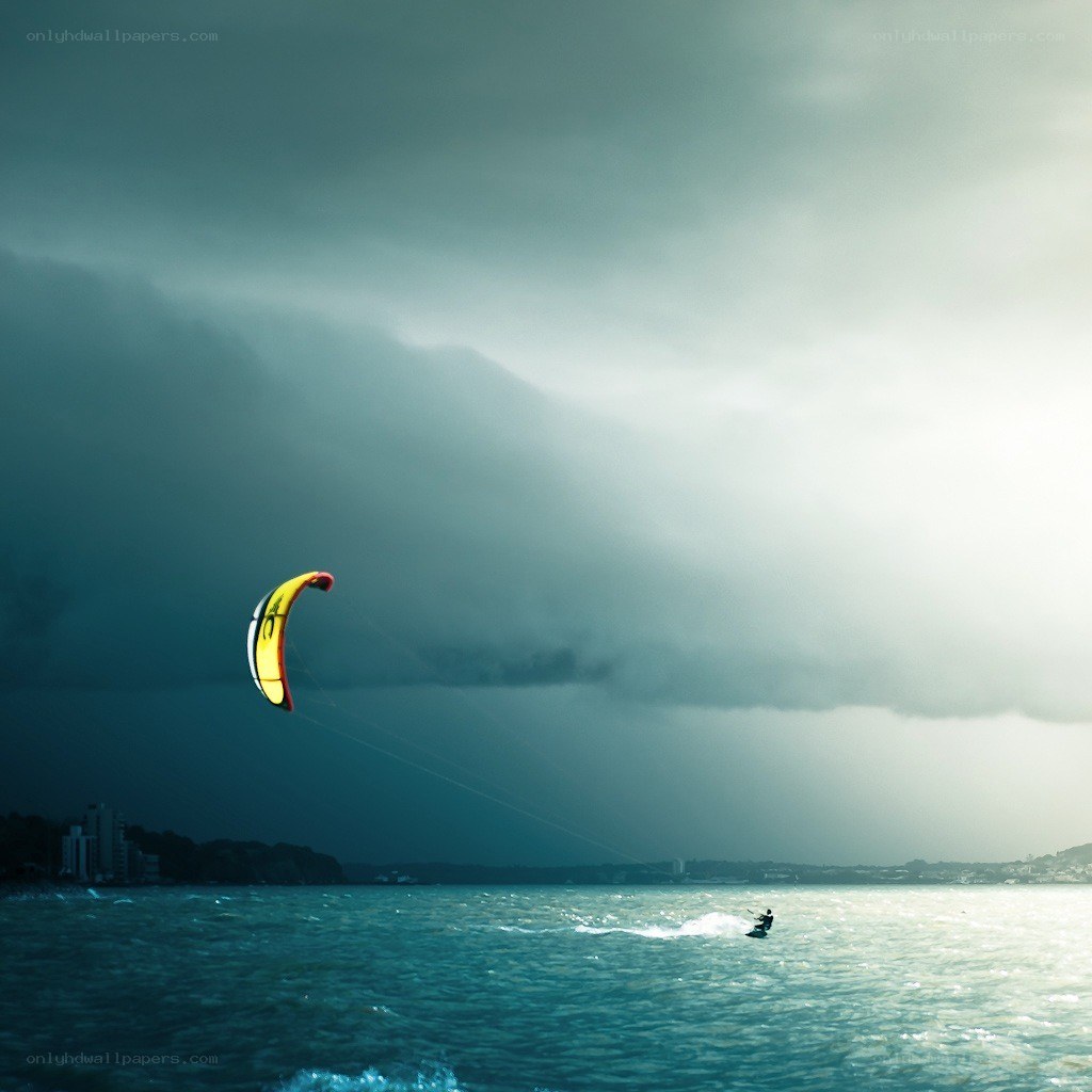 Kite surfer under stormy sky