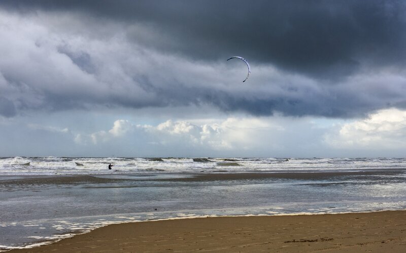 Kite surfing on a stormy beach