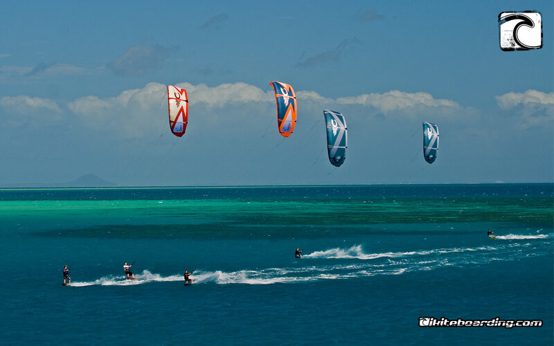 Kiteboarders over turquoise water