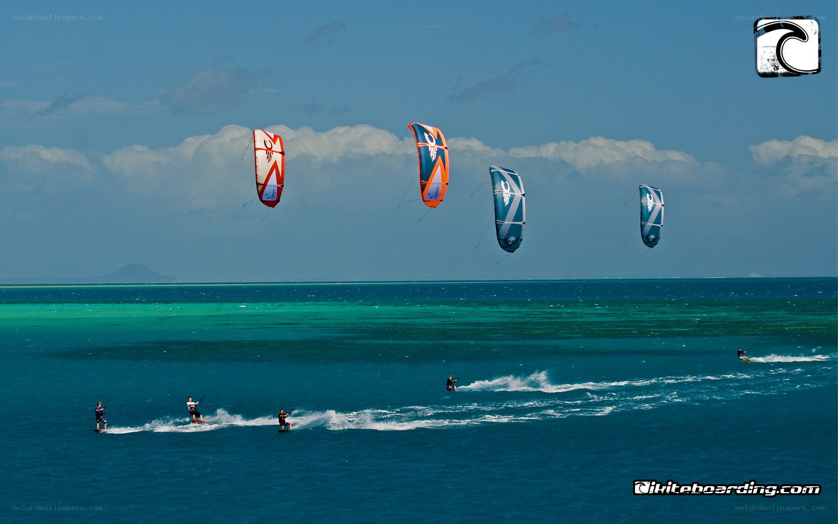 Kiteboarders over turquoise water