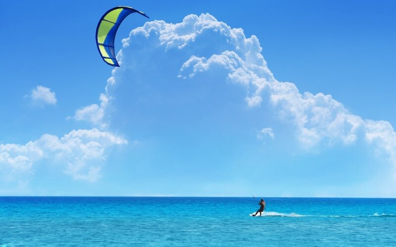 Kiteboarding over blue ocean