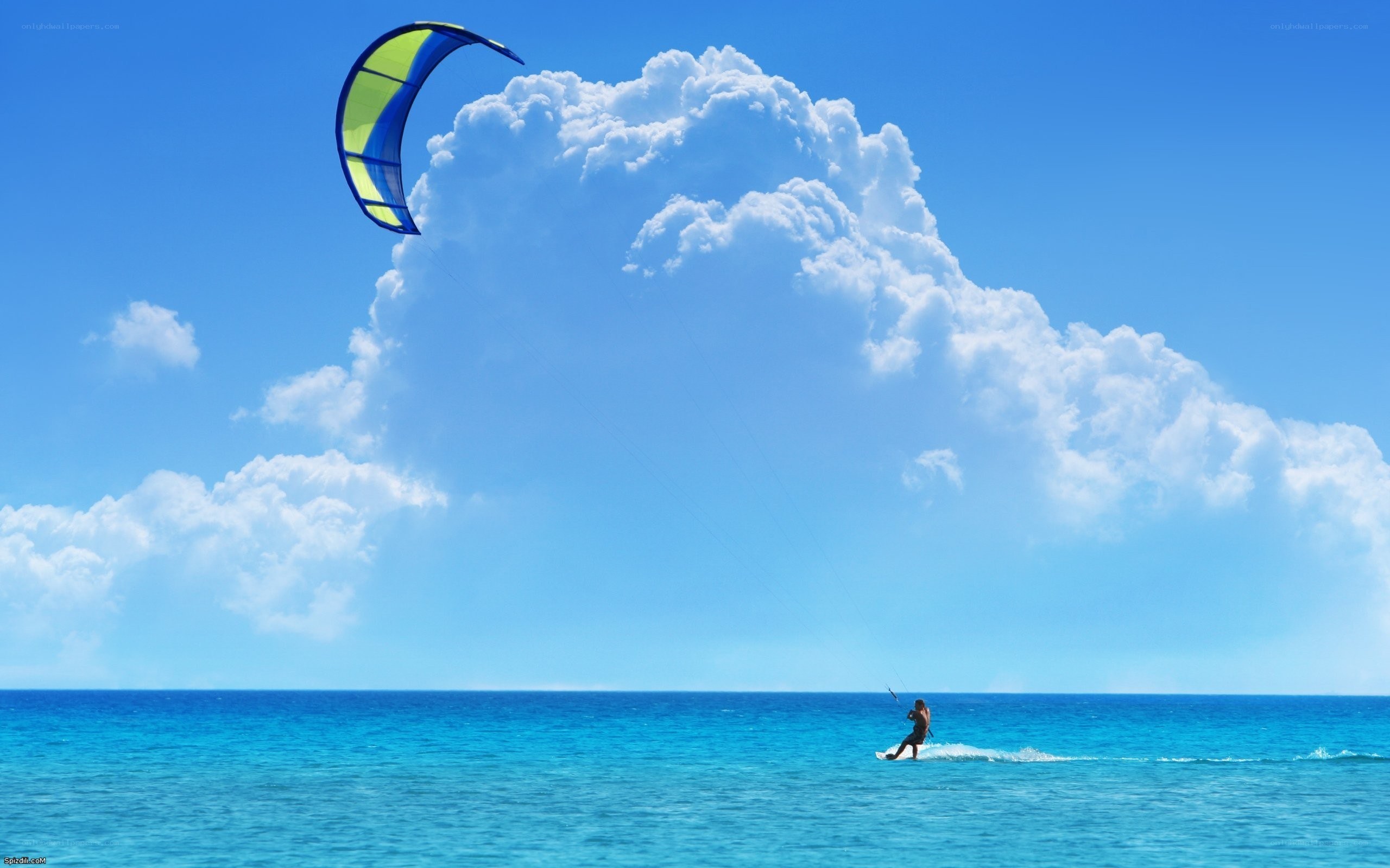 kiteboarding over blue ocean