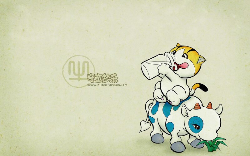 kitten drinking milk on cow