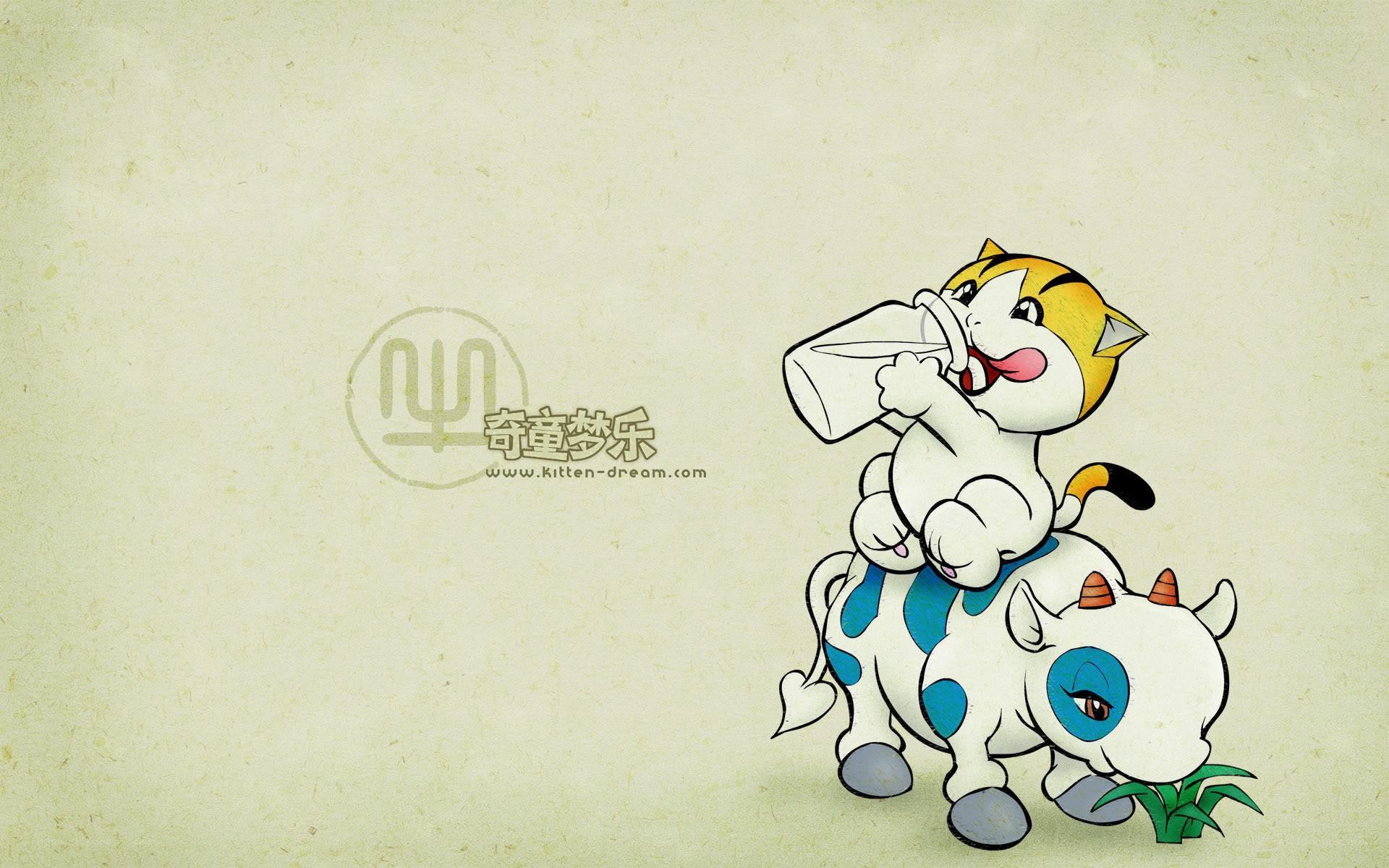 kitten drinking milk on cow
