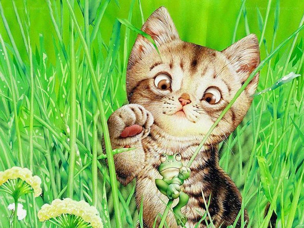 kitten holding a frog in grass