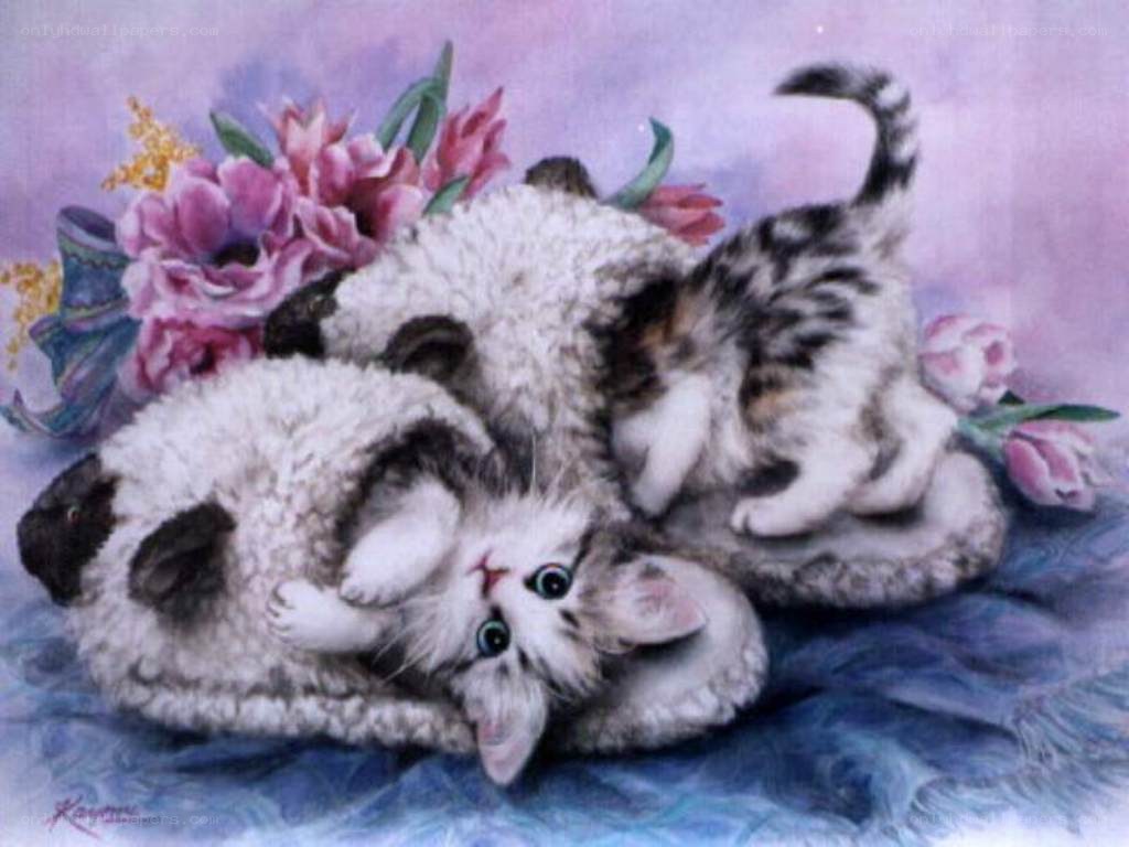 Kittens playing with flowers