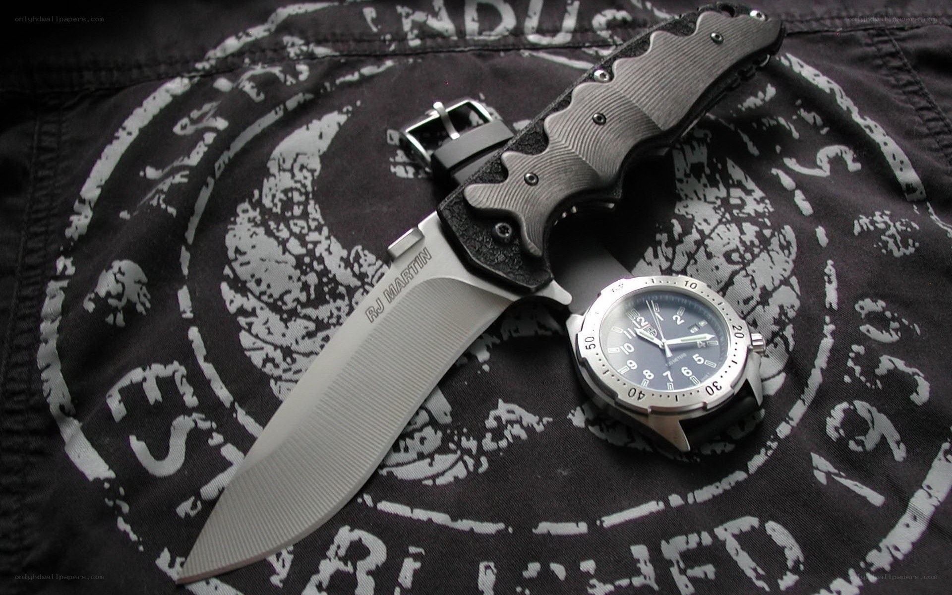 knife and watch on fabric