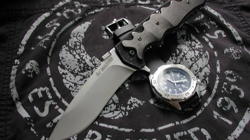 knife and watch on patterned cloth
