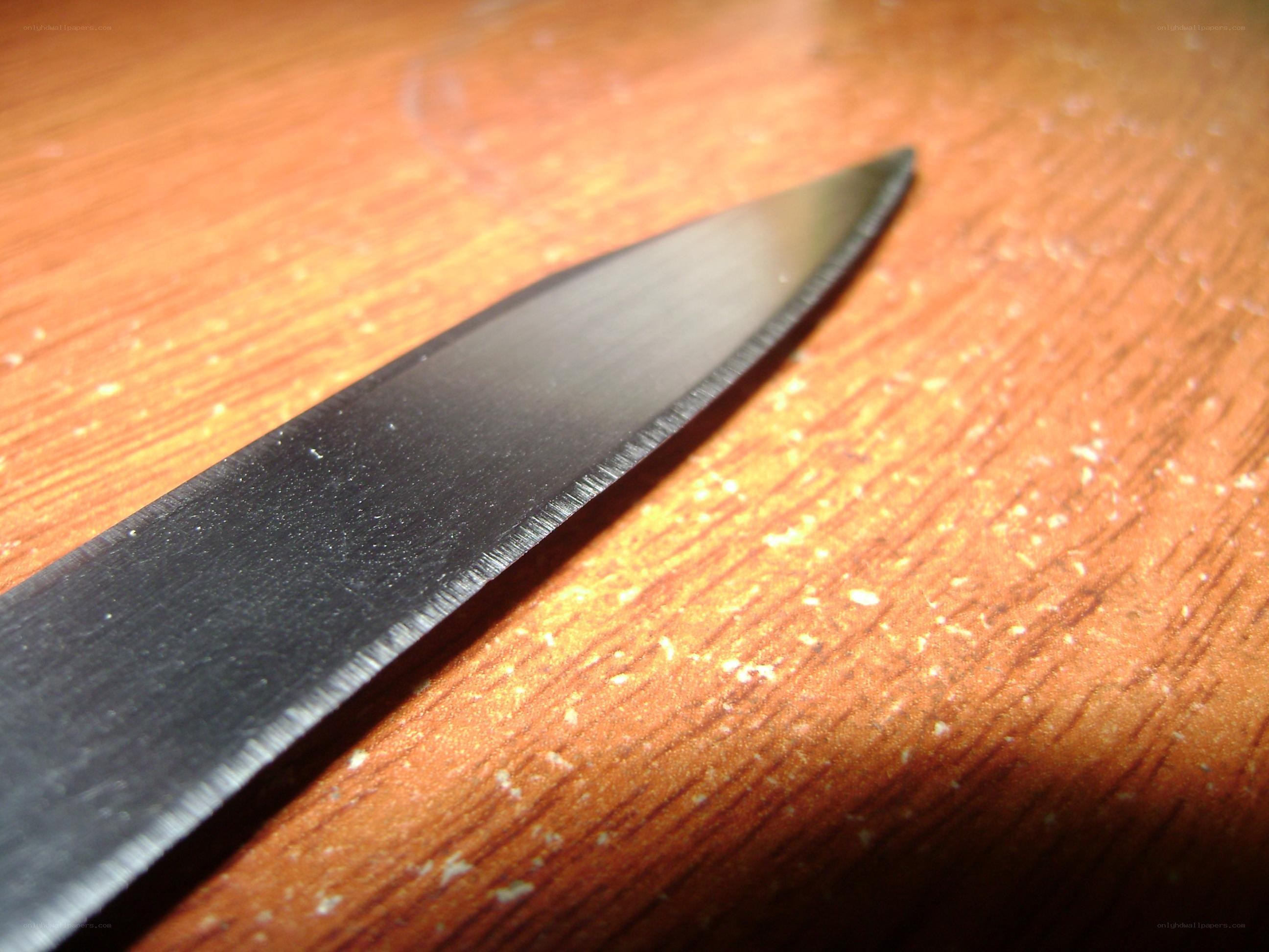 knife blade on wooden surface