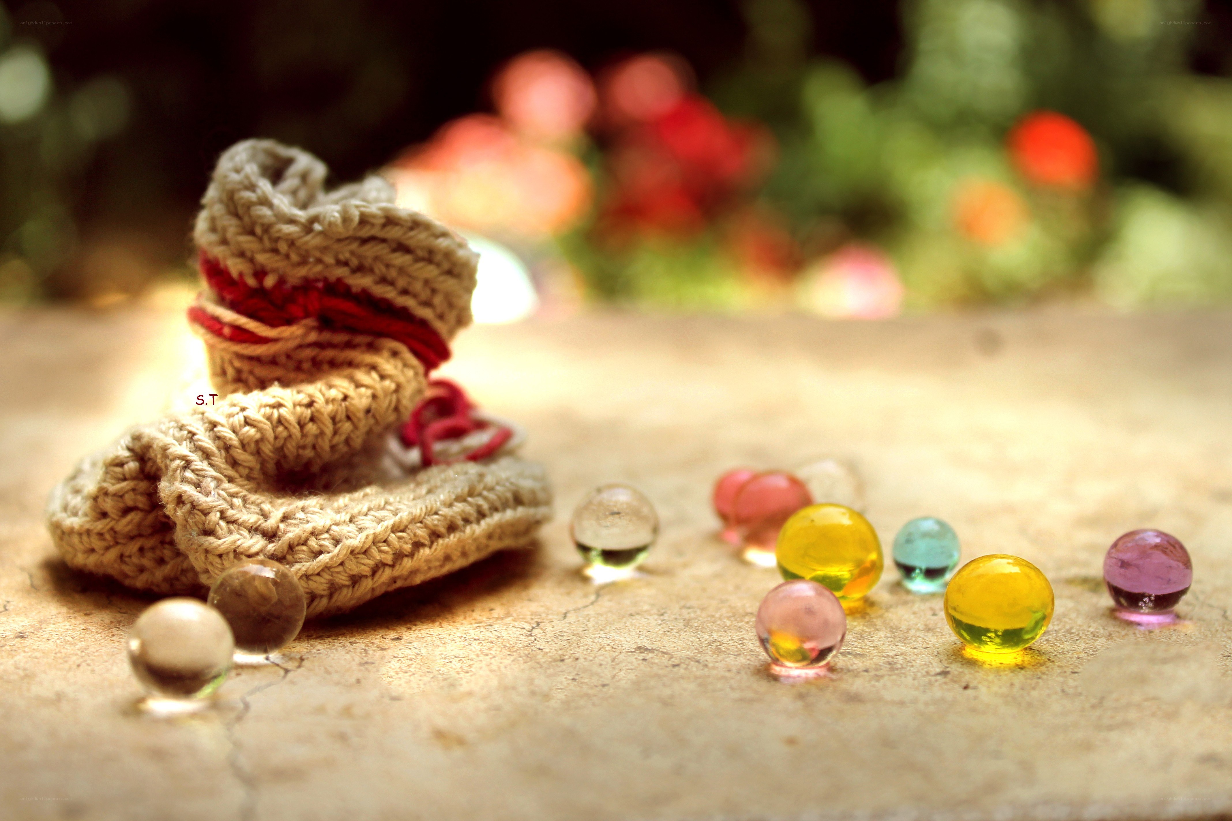 Knitted booties with glass marbles