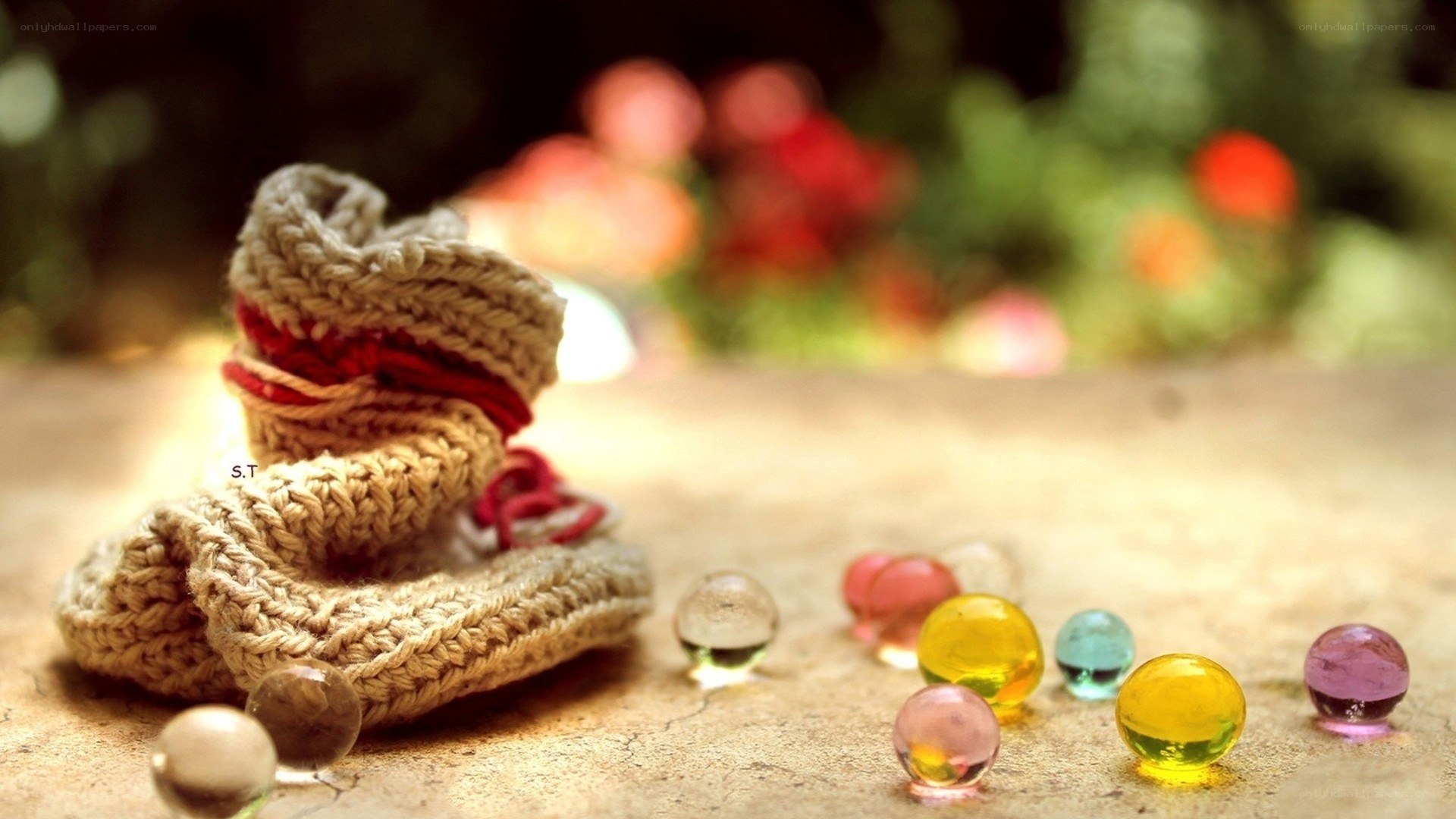 Knitted booties with glass marbles