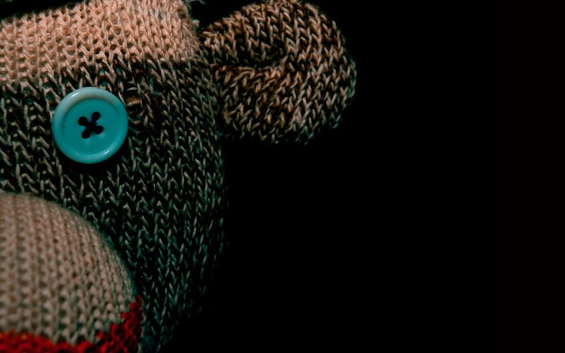 knitted toy with button