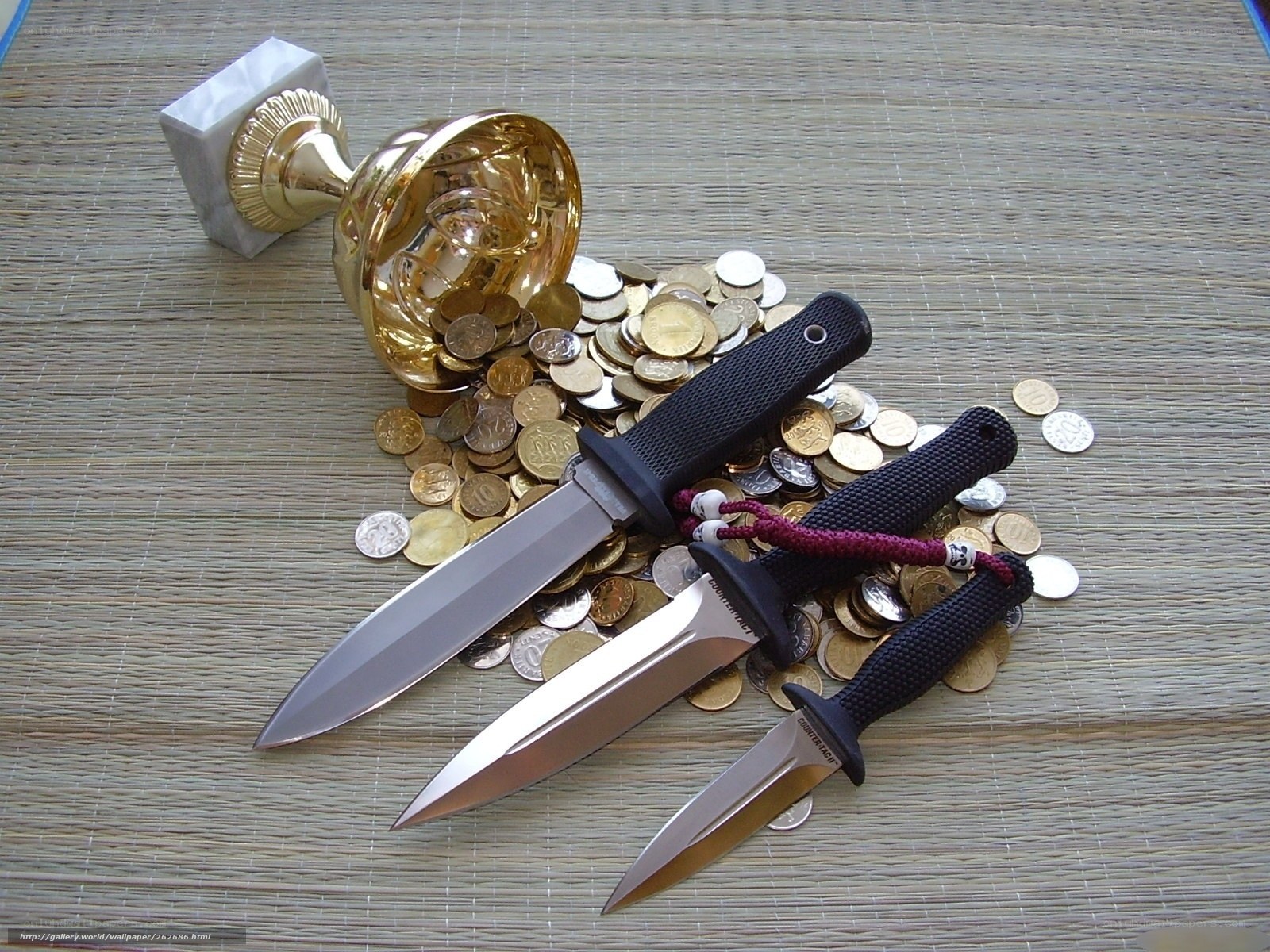 Knives and coins on mat