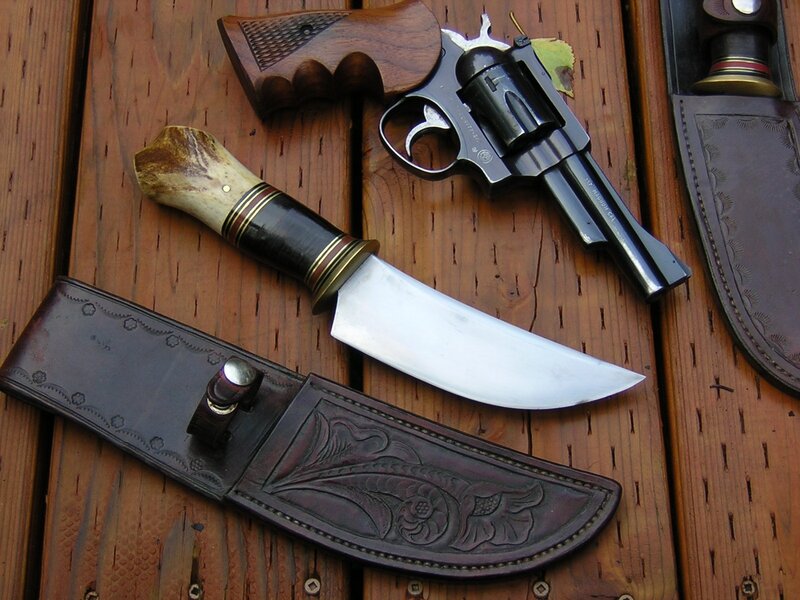 knives and revolver on wood