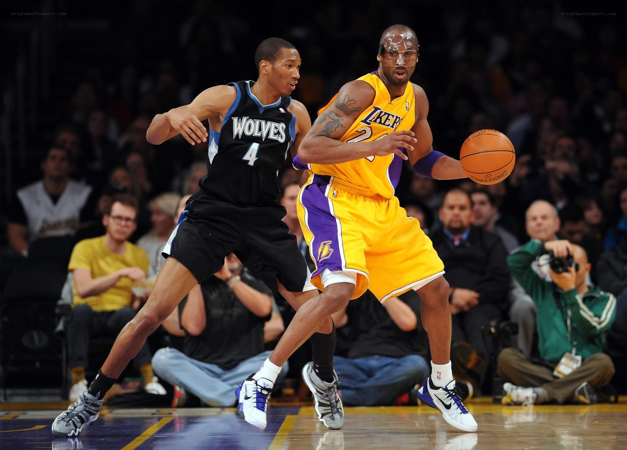 Kobe Bryant drives past defender